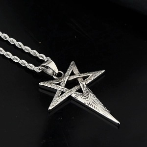 Macro shot of vintage pentagram star pendant with wolf head detail and metal rope chain