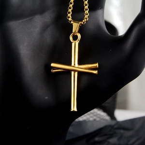 Golden baseball bat cross necklace with bead chain on black display stand
