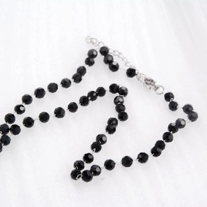 Detail of multi-faceted black beads chain with silver extension link and lobster clasp