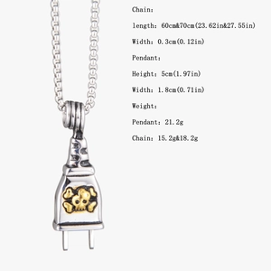 Macro shot of punk style power plug pendant with skull emblem and metal chain dimensions