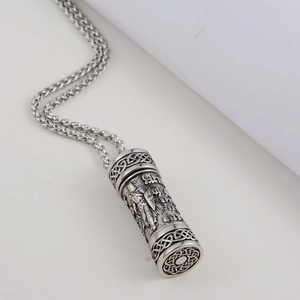 Macro shot of silver warrior perfume pendant with Celtic knot and knight carving