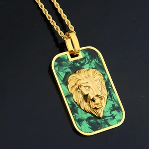Detail of lion head embossed square pendant with green malachite texture and gold rope chain