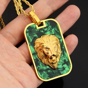 Macro detail of lion head pendant with green marble texture and gold rope chain