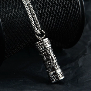 Detailed close-up of a cylinder perfume bottle pendant with Celtic knots on a wheat chain