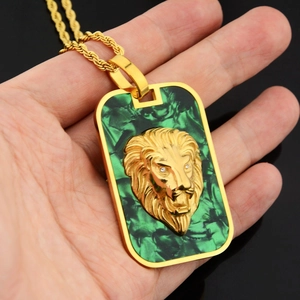 Detail of lion head square pendant with green malachite texture on gold rope chain