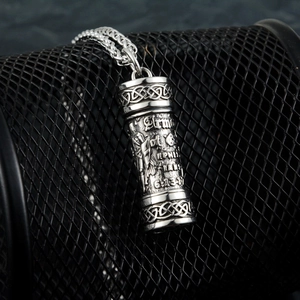 Close-up of silver cylinder pendant with Celtic knots and Armor of God scripture