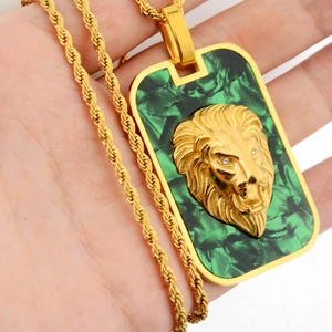 Detailed close-up of a golden lion head square pendant with green marble inlay on rope chain