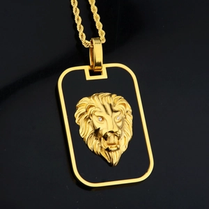 Macro detail of gold lion head pendant on black square base with thick rope chain
