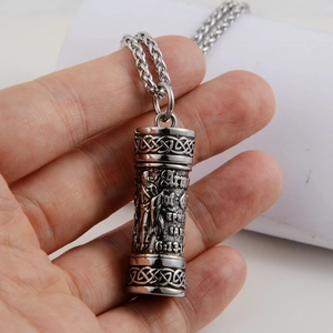 Macro shot of stainless steel cylinder pendant with Armor of God Bible verse engraving