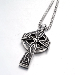 Detailed close-up of retro Celtic knot cross pendant with vintage silver finish and chain