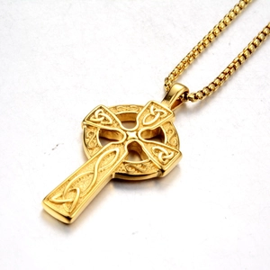 Detailed view of the gold Celtic cross pendant featuring intricate knotwork on box chain