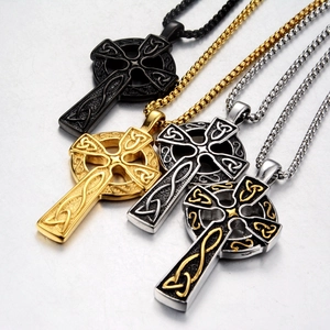 Detail of Celtic knot cross necklaces in black, gold, and silver stainless steel