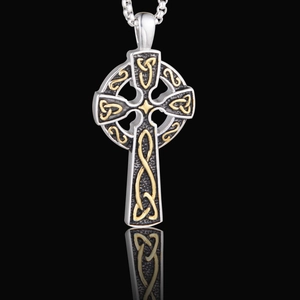 Vintage Celtic cross pendant necklace with silver and gold knot patterns on black backdrop