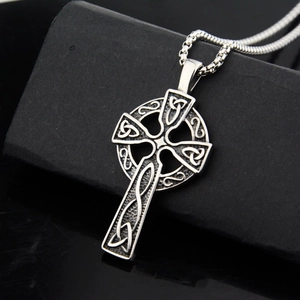 Close-up of vintage Celtic knot cross pendant in stainless steel with antique finish