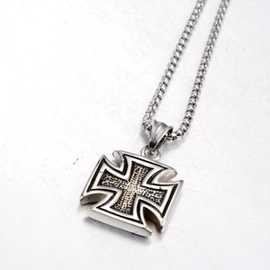 Macro detail of Iron Cross pendant featuring black textured finish and stainless steel ball chain
