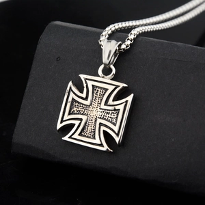 Macro shot of silver iron cross pendant with vintage texture and sleek box chain