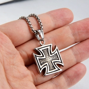 Detailed macro view of the silver Iron Cross pendant necklace with textured engraving