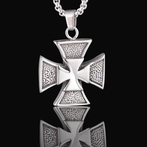 Macro detail of silver iron cross pendant featuring hammered texture and polished center