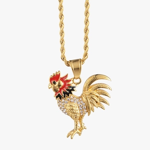 Macro detail of golden rooster pendant with red enamel comb and sparkling cubic zirconia