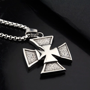 Detail view of silver iron cross necklace with textured surface and durable box chain