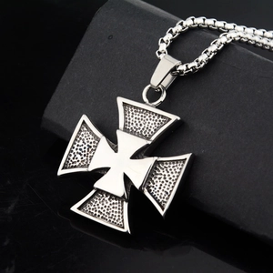 Detail of silver cross pendant with dot textures and polished steel chain