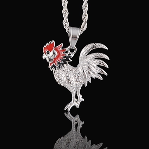 Macro view of rooster pendant with crystals and enamel detailing on a rope chain