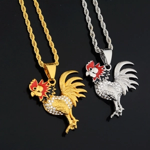 Macro detail of rooster zodiac pendants in gold and silver with sparkling rhinestones
