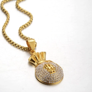 Macro shot of hip hop dollar sign money bag pendant with shimmering white cubic zirconia