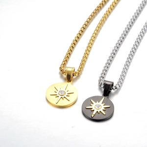 Detail of sunburst pendant necklace in gold and black with zircon and box chain