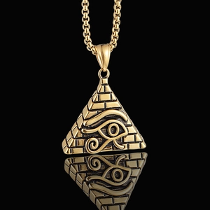 Golden pyramid pendant necklace with Eye of Horus relief on a polished black background