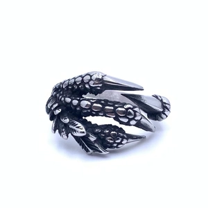 Detailed close-up of retro silver dragon claw ring showing scale texture and punk style