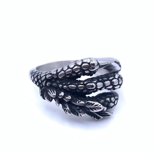 Detailed view of retro dragon claw ring featuring intricate scales and gothic textures