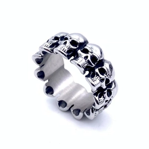 Macro shot of silver stainless steel skull ring with vintage gothic skeleton carvings