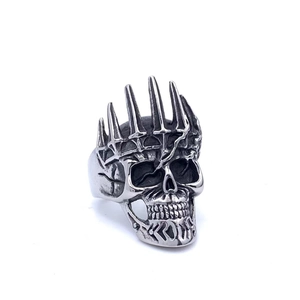 Macro view of vintage silver skull ring with a spiked crown and antique gothic texture