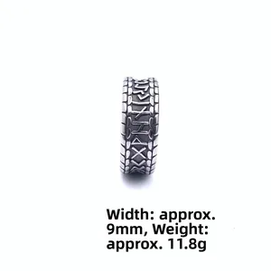 Macro view of vintage Viking runes ring, 9mm width stainless steel band with relief texture