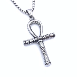 Detail view of vintage silver Ankh cross pendant with Eye of Horus and hammered texture