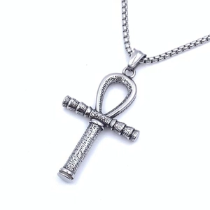 Detailed macro view of vintage stainless steel Ankh cross pendant with box chain