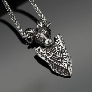 Macro detail of vintage Viking goat head pendant with Valknut symbol on arrow steel base