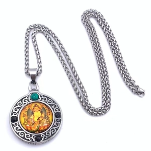 Detalle del colgante thangka de Jambhala amarillo con cuenta turquesa y cadena de acero