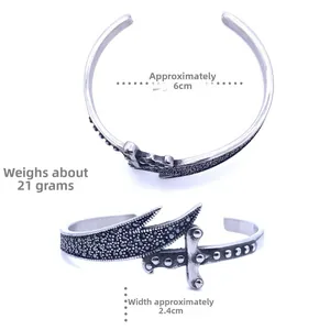 Macro detail of vintage silver sword bracelet with textured surface and stud accents