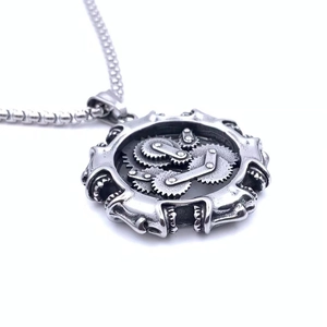 Detailed view of steampunk gear pendant with intricate mechanical wheels on bead chain