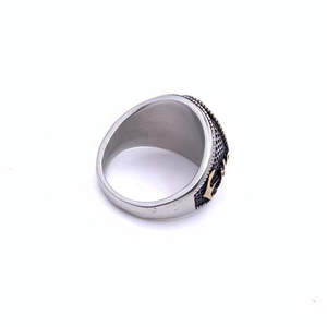 Detailed side view of men's steel ring with golden anchor and black honeycomb pattern