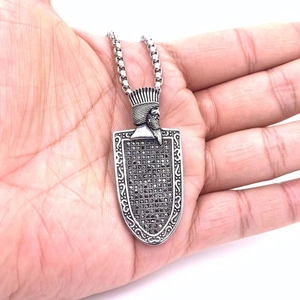 Vintage silver shield pendant with king relief and black zircons on steel chain