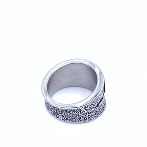 Macro shot of industrial wide band ring showing vintage silver lava texture and smooth inner surface