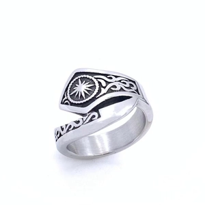 Detailed macro view of retro sunburst star engraving on stainless steel signet ring