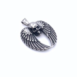 Detailed close-up of retro silver skull and demon wings pendant in stainless steel