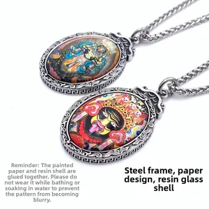 Close-up of oval Thangka pendant with steel frame and resin glass protective layer
