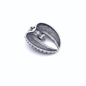 Close-up of vintage titanium steel devil wing pendant with detailed gothic texture
