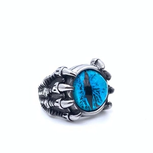 Macro view of punk style men's dragon claw ring holding a detailed blue evil eye stone