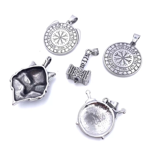 Detailed close-up of vintage Viking pendants with Mjolnir and Nordic rune engravings